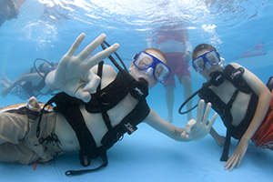 Scouts practice an introduction to scuba diving in a pool.